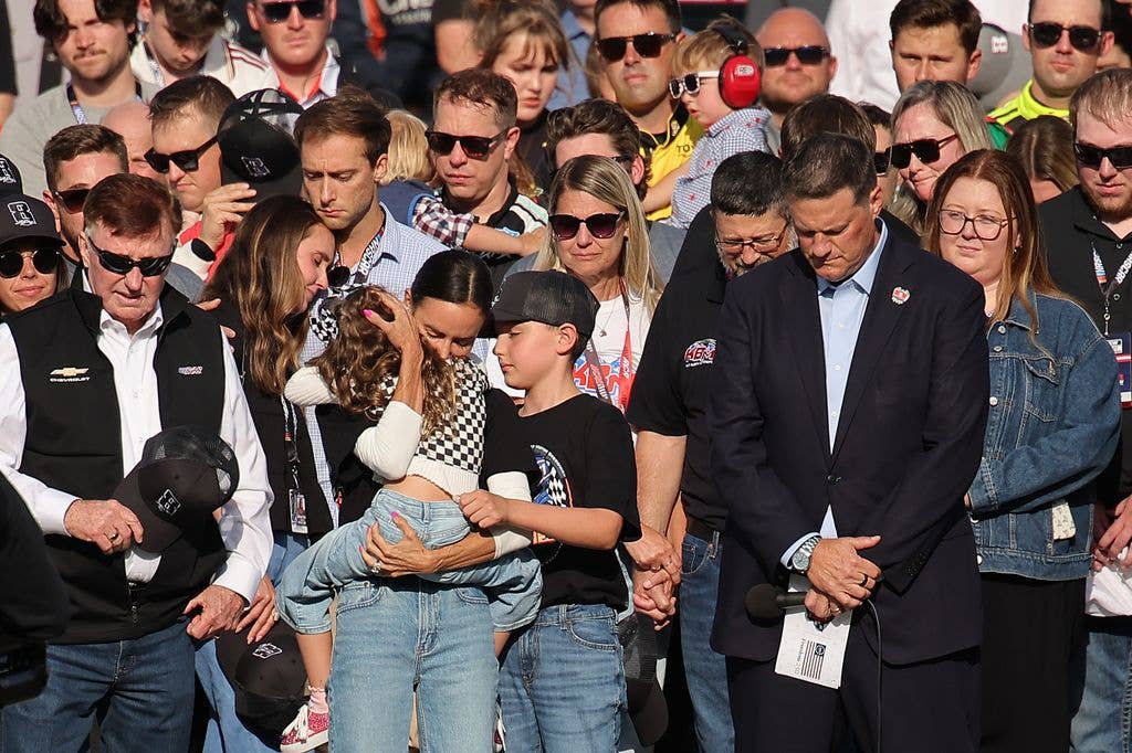 Samantha Busch (wife) holds daughter Lennix Busch and son Brexton Busch on the grid during the remembrance ceremony for Kyle Busch