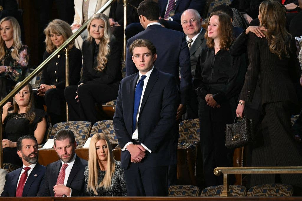 photo of barron trump standing in the house of chamber of us capitol