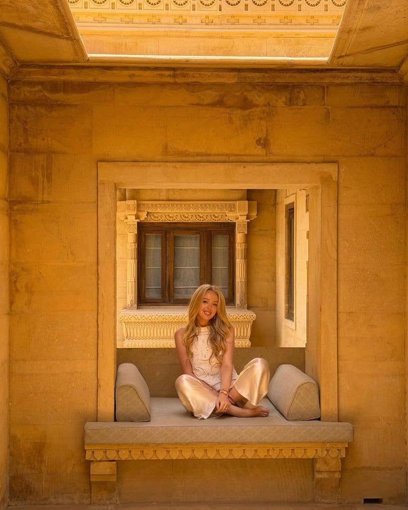 Tiffany wearing silk trousers and white top
