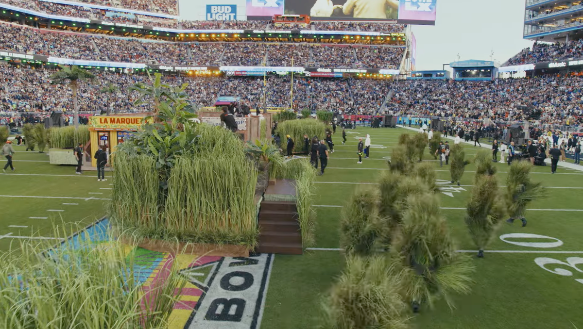 The halftime show transformed Levi's Stadium into a vibrant Puerto Rican-inspired landscape complete with a neighborhood house, a vintage truck, a wedding scene, street vendors, and hundreds of performers.
