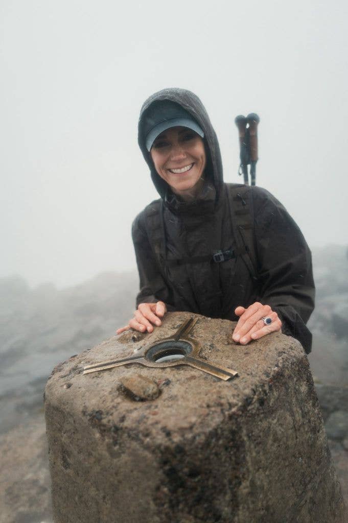 Princess Kate in a baseball cap hiking up a mountian 