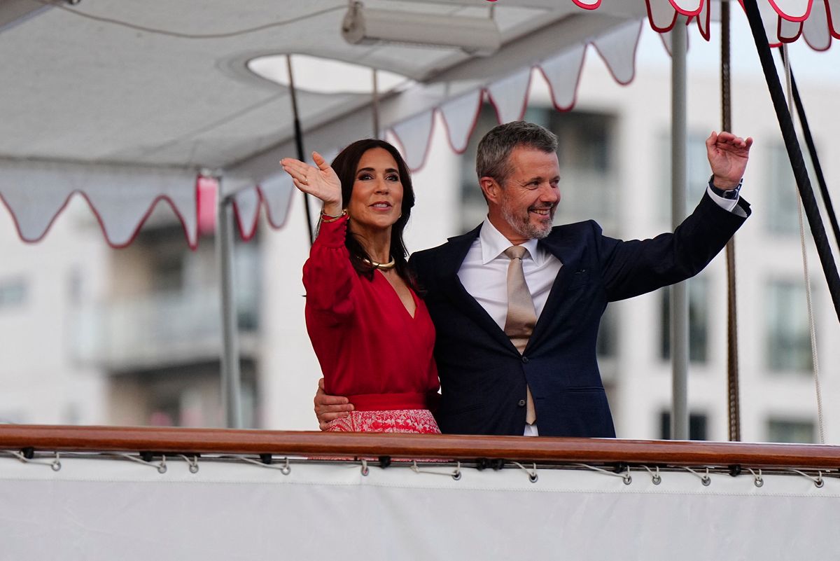 Queen Mary changed into a vibrant scarlet dress for an evening reception aboard the Royal Yacht Dannebrog.