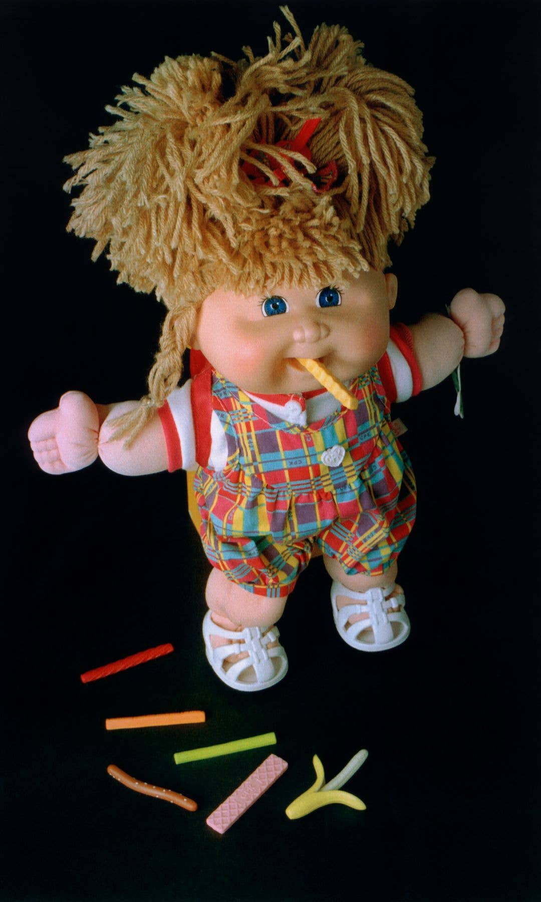 A Snacktime Cabbage Patch Kid with a chip in its mouth