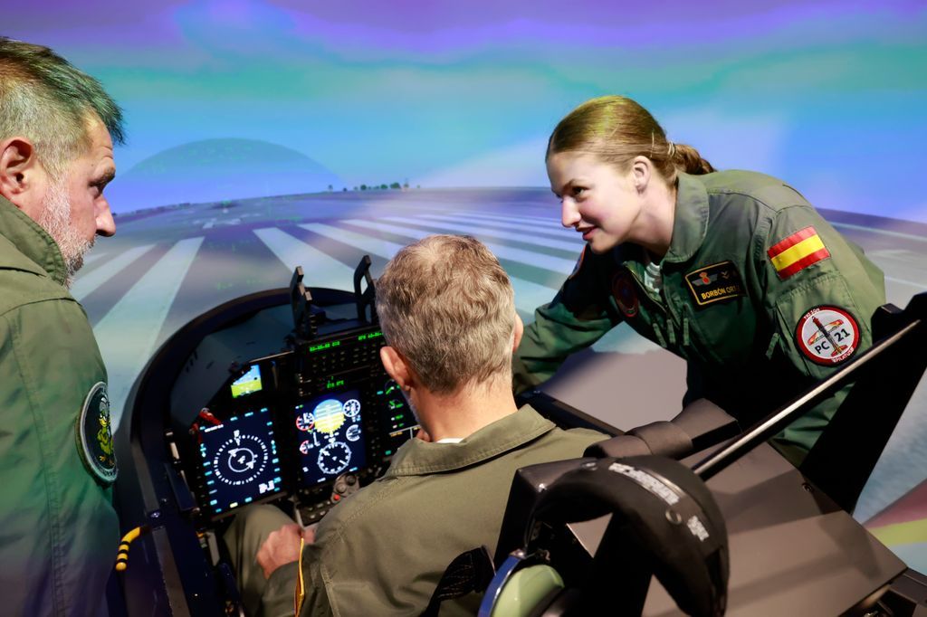 King Felipe VI listens attentively as Princess Leonor explains details of the flight mission.