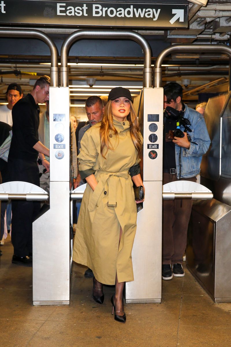 

Jennifer kept her look chic yet understated in a trench coat-style dress paired with tights, heels, and a black cap, blending into the city commute while traveling with security during the Manhattan-to-Coney Island filming route.