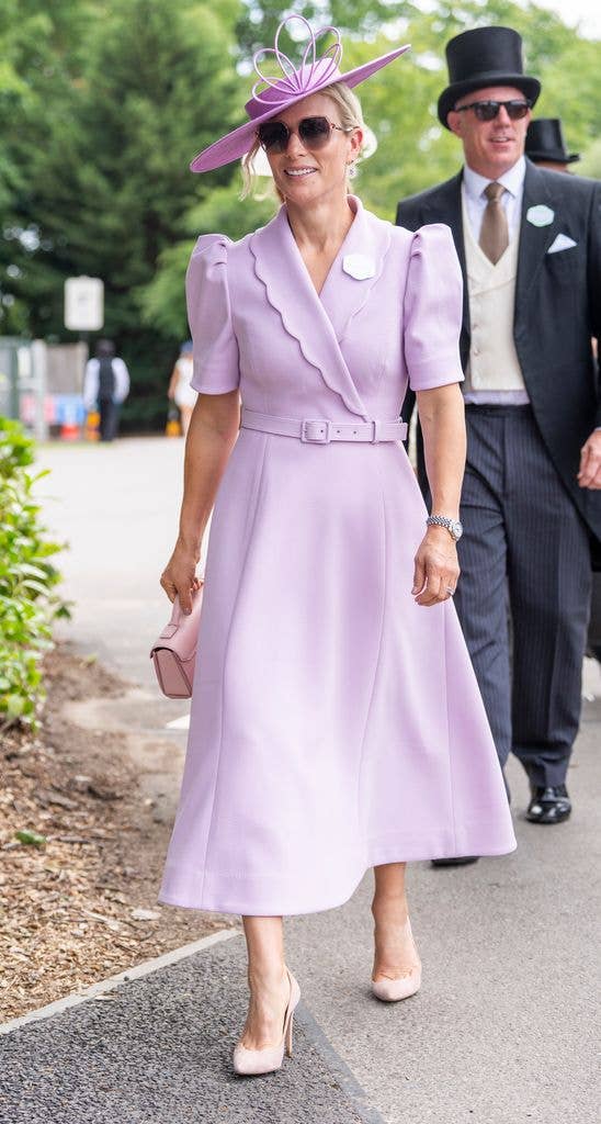 Zara Tindall wears a pale pink belted dress with matching hat