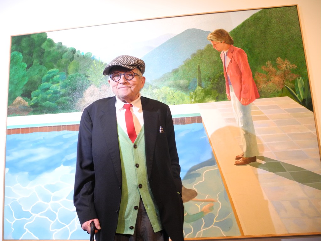 David Hockney standing in front of his "Portrait of an Artist (Pool with Two Figures)" painting at the Metropolitan Museum of Art in New York, USA, 20 November 2017. The Museum is dedicating a large retrospective to the work of Hockney, which spans almost 60 years. Photo: Johannes Schmitt-Tegge/dpa (Photo by Johannes Schmitt-Tegge/picture alliance via Getty Images)