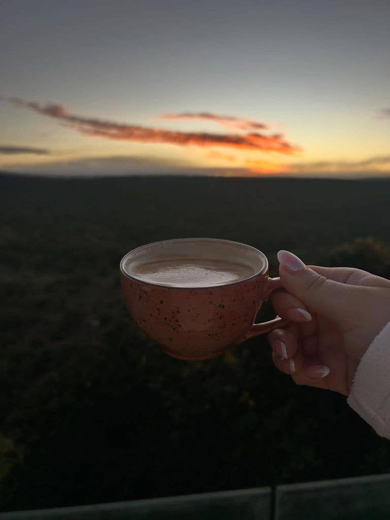 A photo of a coffee cup against a sky