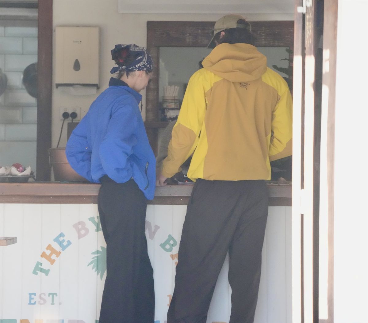 The rumored couple kept their off-duty style understated while stopping together during their Australian getaway.