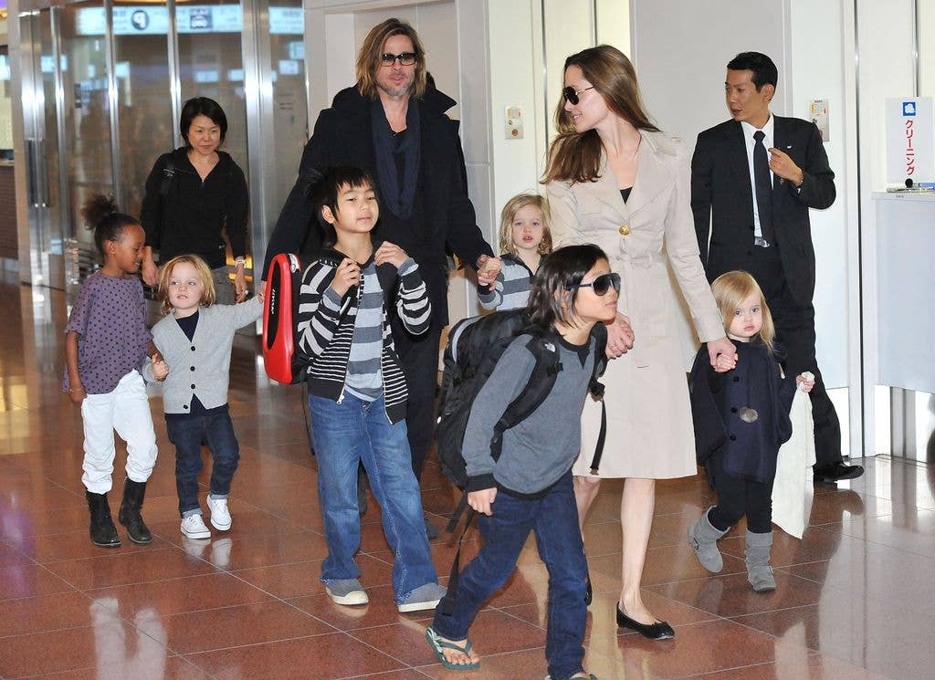 Angelina, Brad Pitt, and their six children Maddox, Pax, Zahara, Shiloh, Knox, and Vivienne arrive in Tokyo