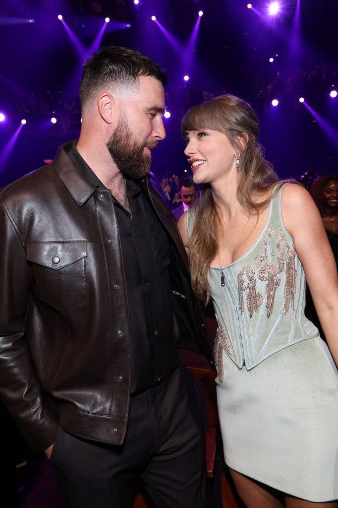 photo of travis kelce and taylor swift smiling at each other