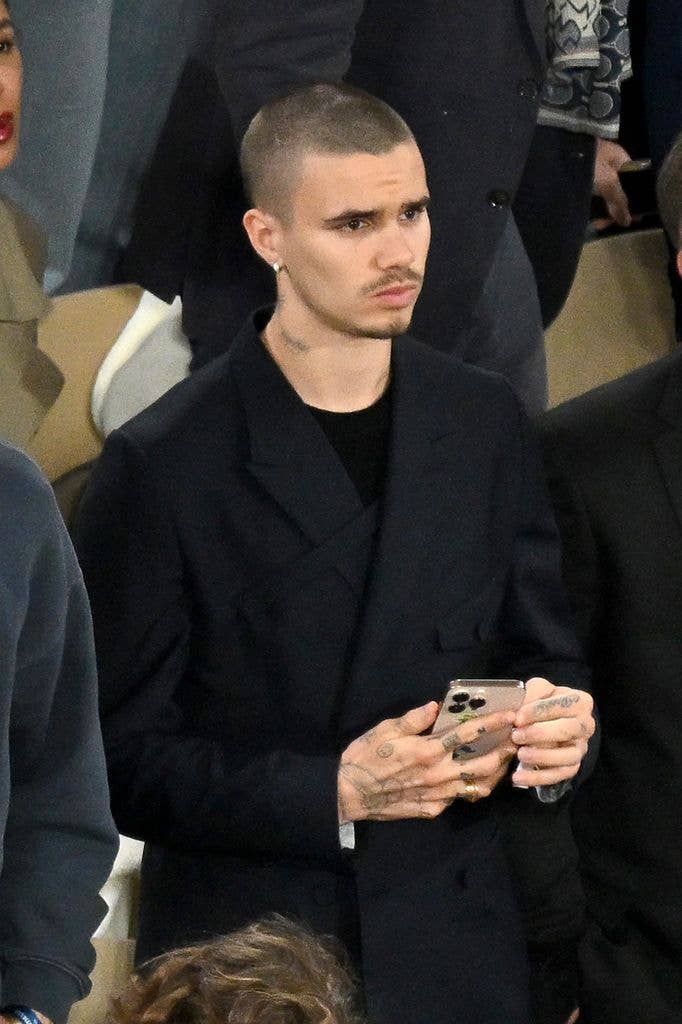 Romeo Beckham with a blank expression