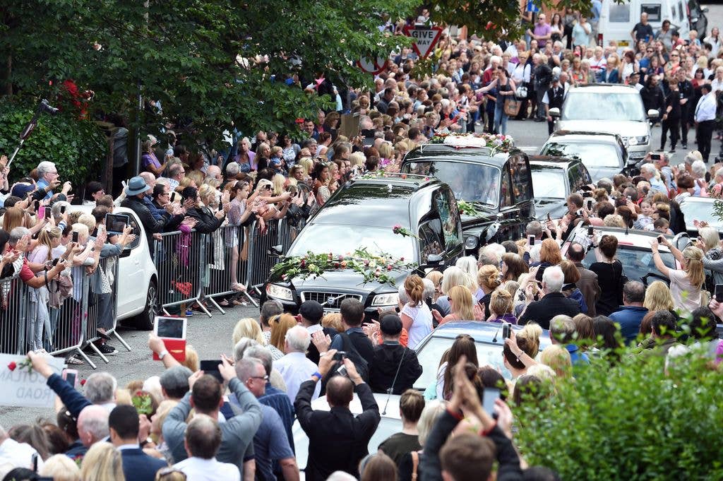 Fans line a two mile stretch of Woolton Road as Cilla Black's hearse arrives at St Mary's Church in Liverpool.