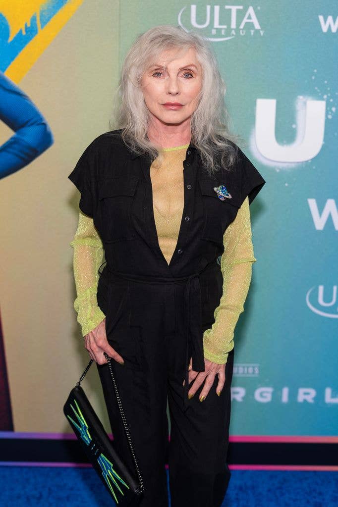 photo of debbie harry in black jumpsuit and green top