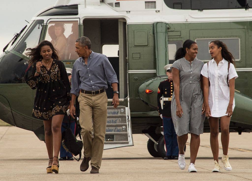 US President Barack Obama, First Lady Michelle Obama and daughters Sasha (L) and Malia (R) in 2016 