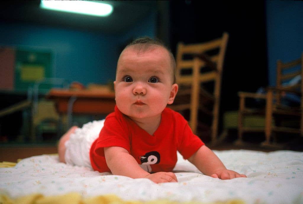 RAHWAY, UNITED STATES - JUNE 01:  A cute wide-eyed infant perking head up on blanket on floor at the daycare center at First Presbetyrian Church funded by Merck Pharmaceuticals for their employee's children.    (Photo by Bill Foley/Getty Images)