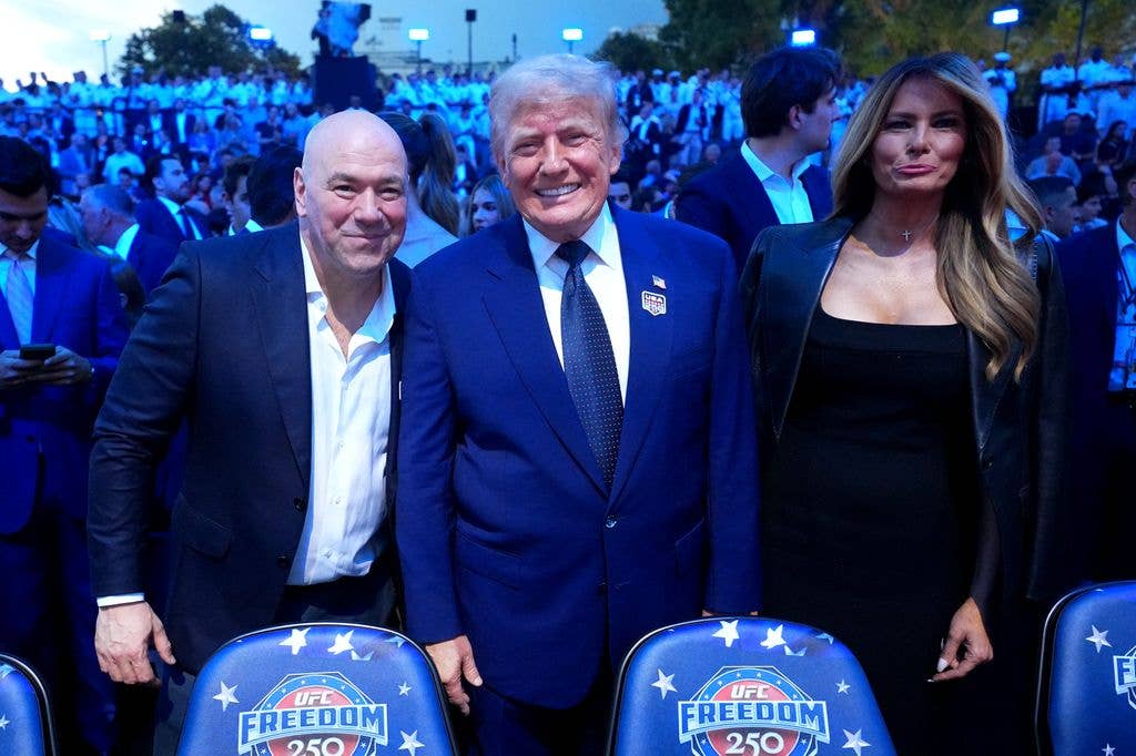 (L-R) UFC President and CEO Dana White, U.S. President Donald J. Trump and First Lady of the United States Melania Trump pose for a photo