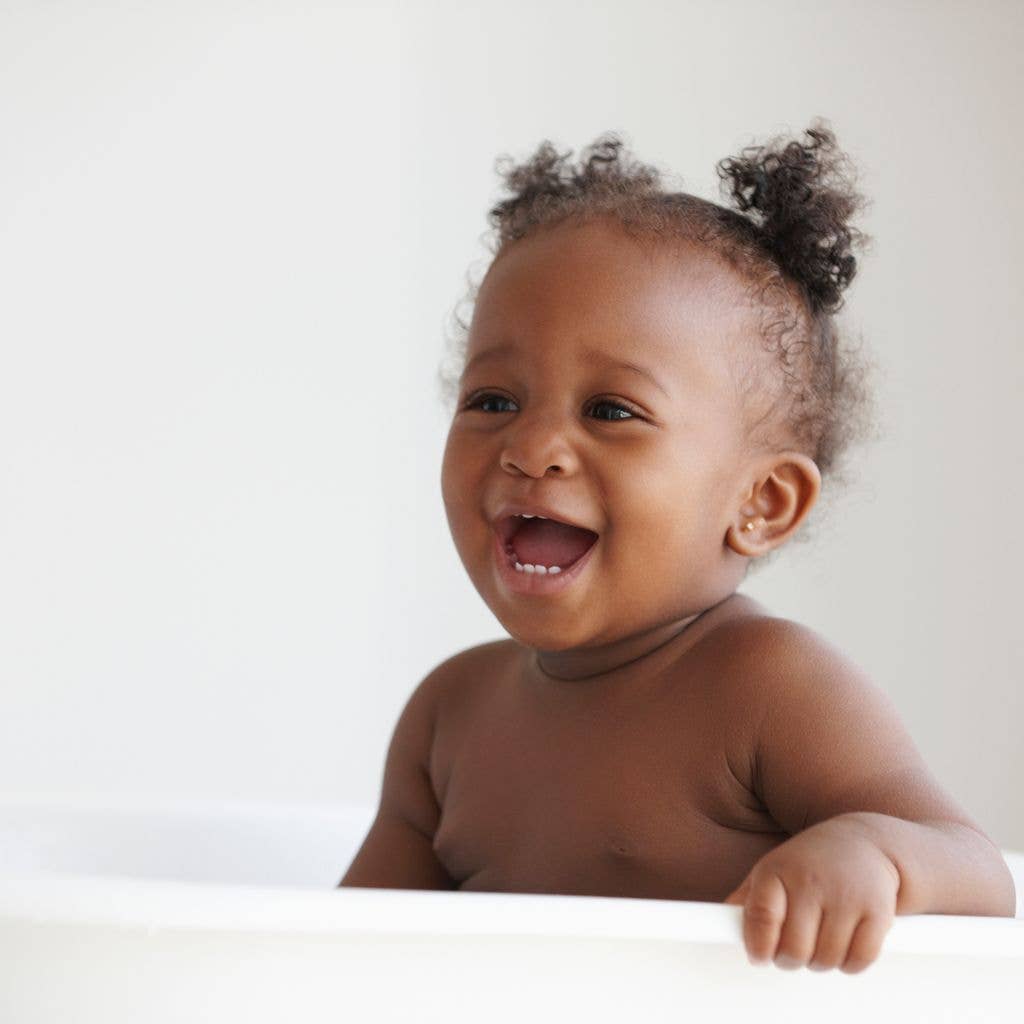 Laughing Baby Girl Sitting In Bathtub