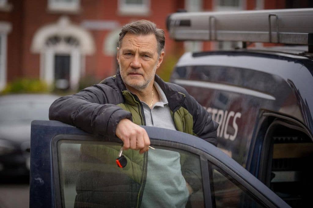 A man leans on a van door