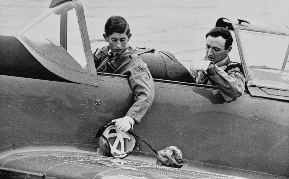 Prince Charles retrieves his flying helmet before his first flying lesson in an RAF Chipmunk at RAF Tangmere, Sussex, on August 1, 1968.