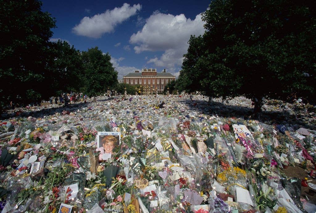 Flower bouquets, cards and photos left for Princess Diana at Kensington Palace.