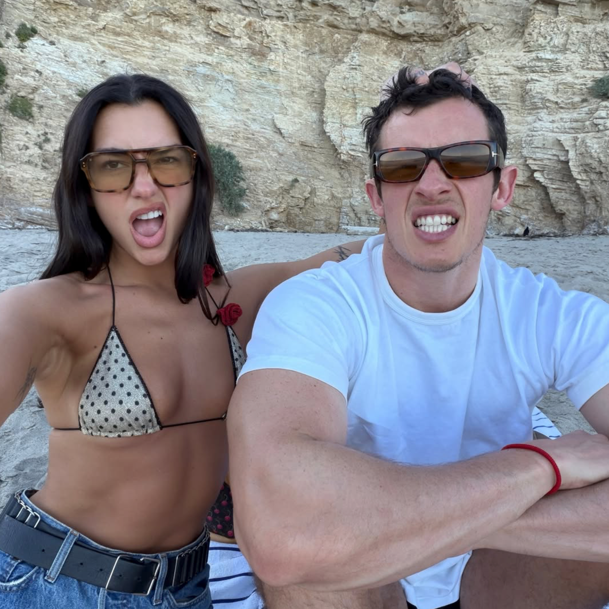 Dua Lipa turns up the heat in sparkly gold triangle bikini and denim shorts on romantic beach date