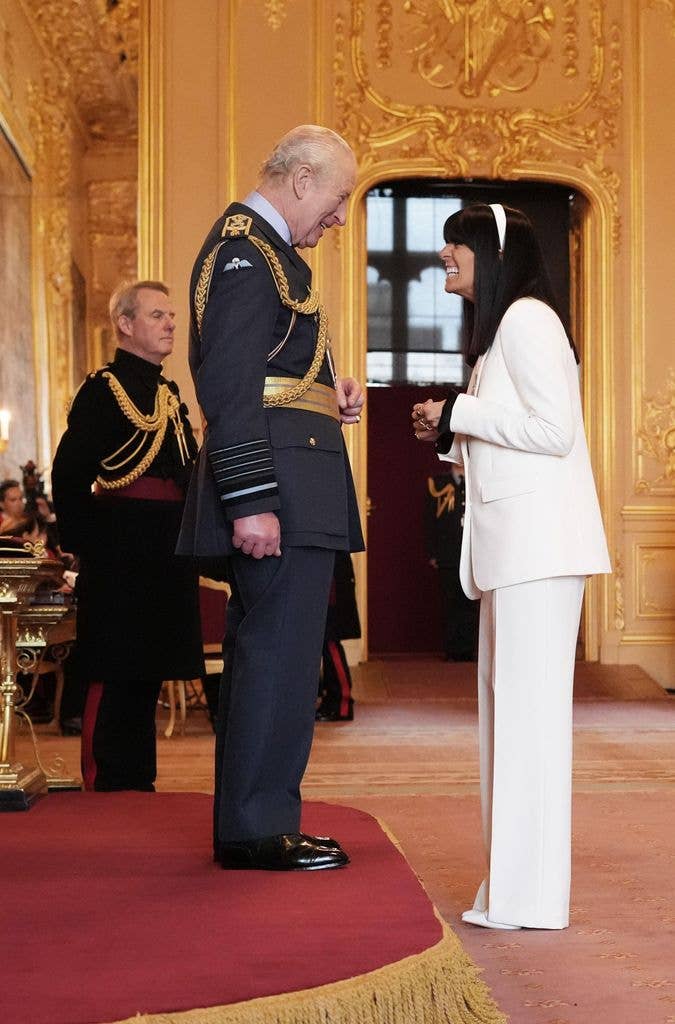 King Charles with Claudia Winkleman at an investiture ceremony