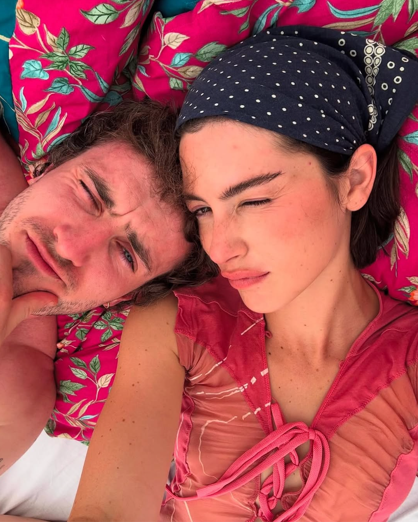 A photo of Paul Mescal and Gracie Abrams lying down on a blanker