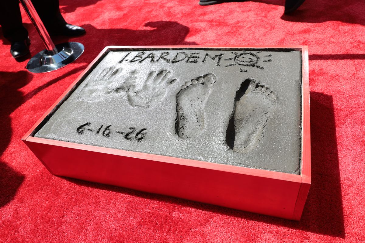 Bardem beams as he signs his name beside his handprints at the TCL Chinese Theatre on June 16, 2026.