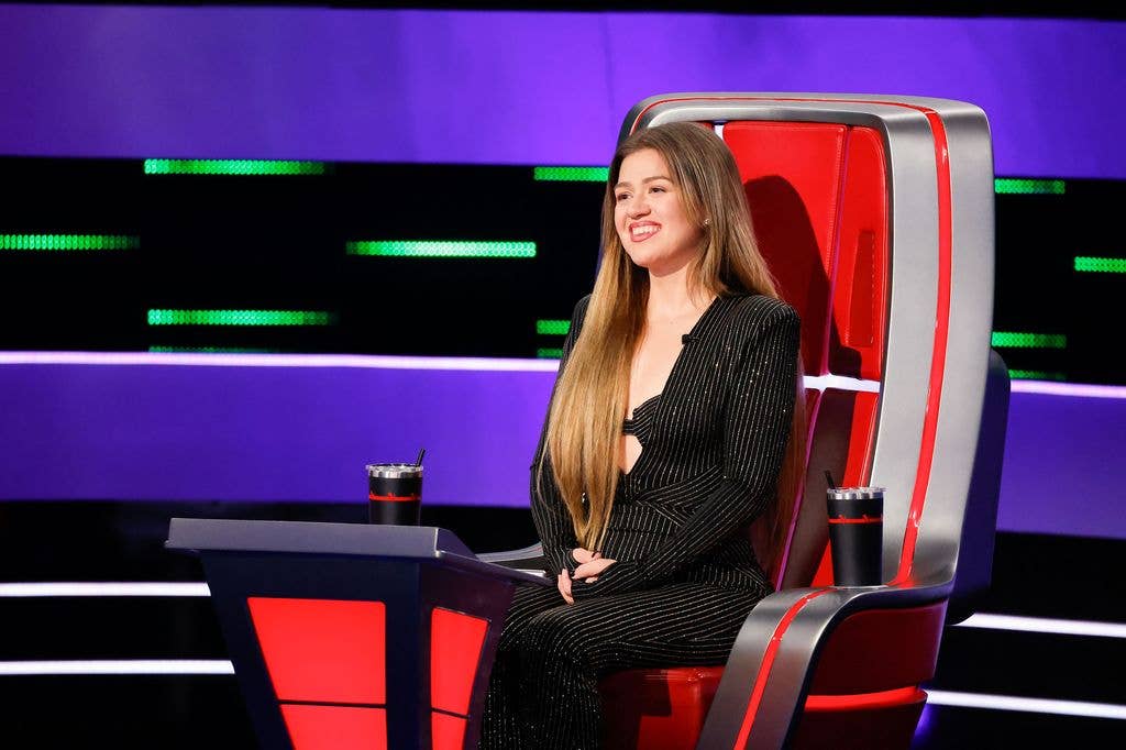 photo of kelly clarkson sitting in red chair on the voice