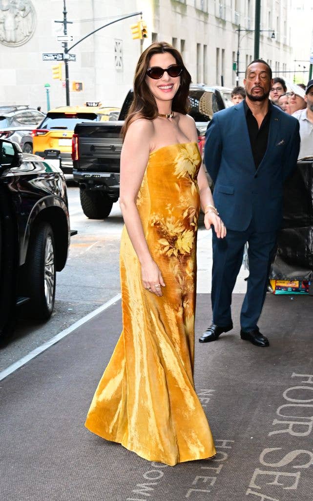 Anne Hathaway wearing a gold dress