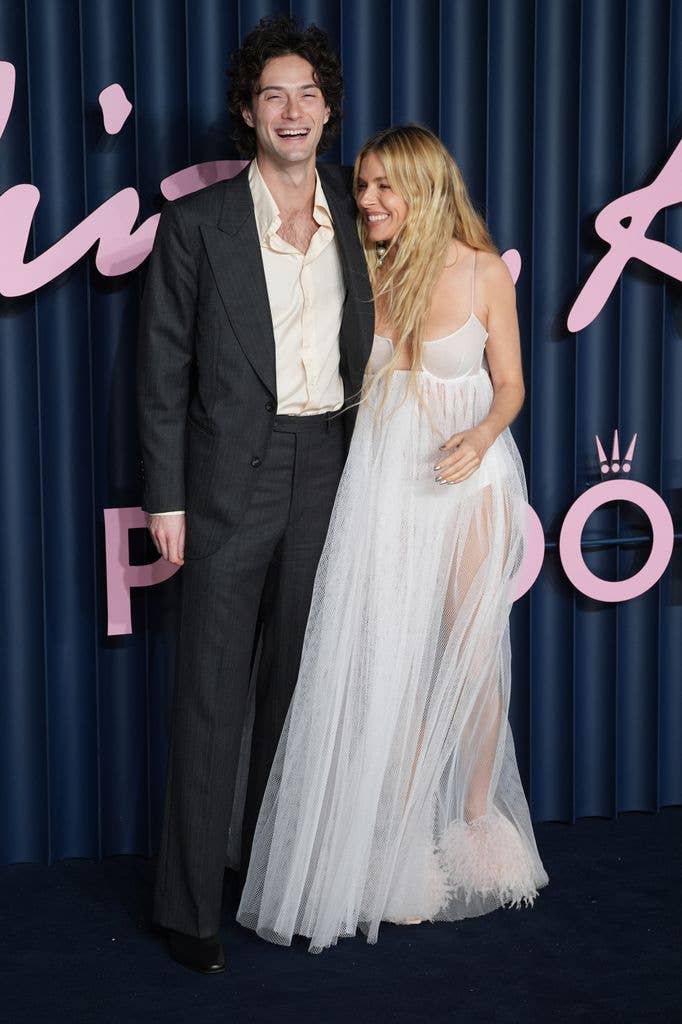 A photo of Sienna Miller and Oli Green laughing