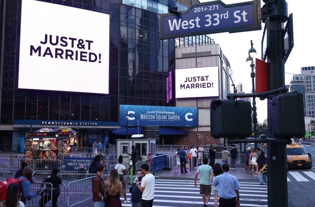 A giant screen shows the message "JUST&T MARRIED!" outside Madison Square Garden