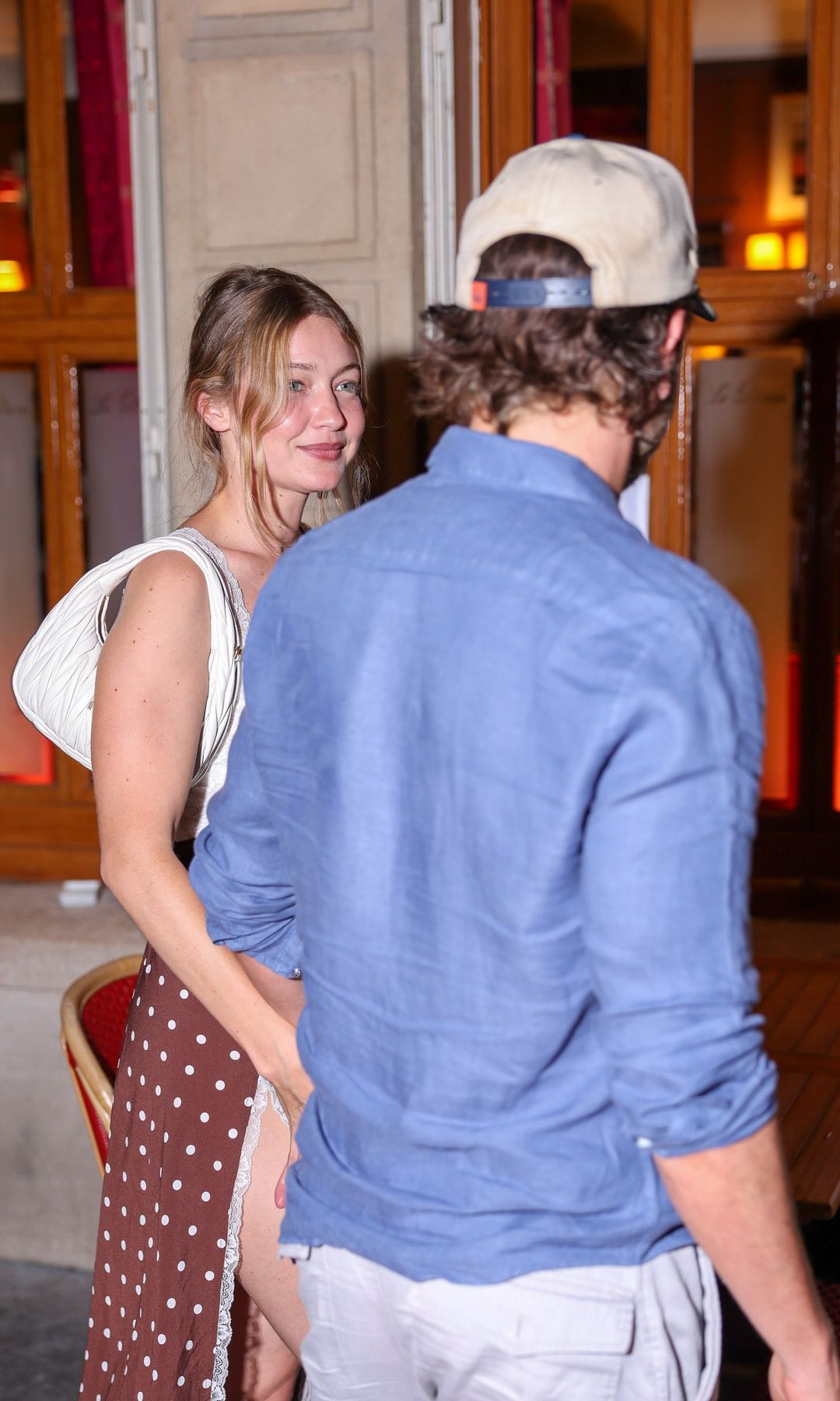Cooper and Hadid held hands as they walked out of the restaurant