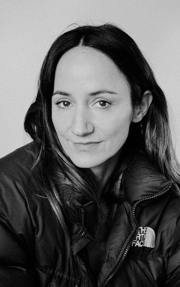 Lydia Leonard in a black North Face jacket, smiling at the camera.