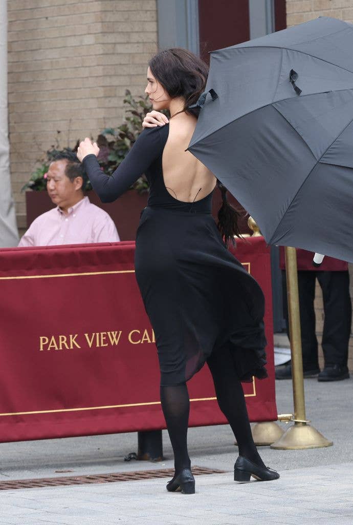 Margaret Qualley wearing a backless black dress