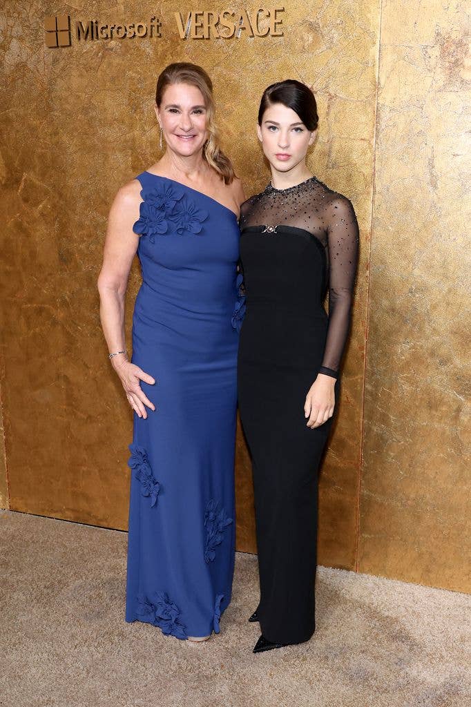 Melinda Gates and Phoebe Gates stand together in front of a gold backdrop.