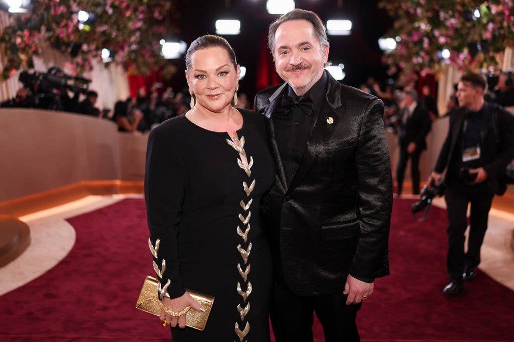 Melissa McCarthy and Ben Falcone pose for photos on the red carpet at the 83rd Annual Golden Globes
