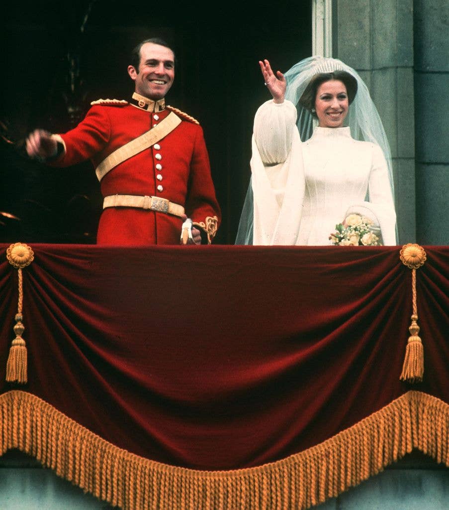 Princess Anne and Captain Mark Phillips waving on the balcony of Buckingham Palace on their wedding day.