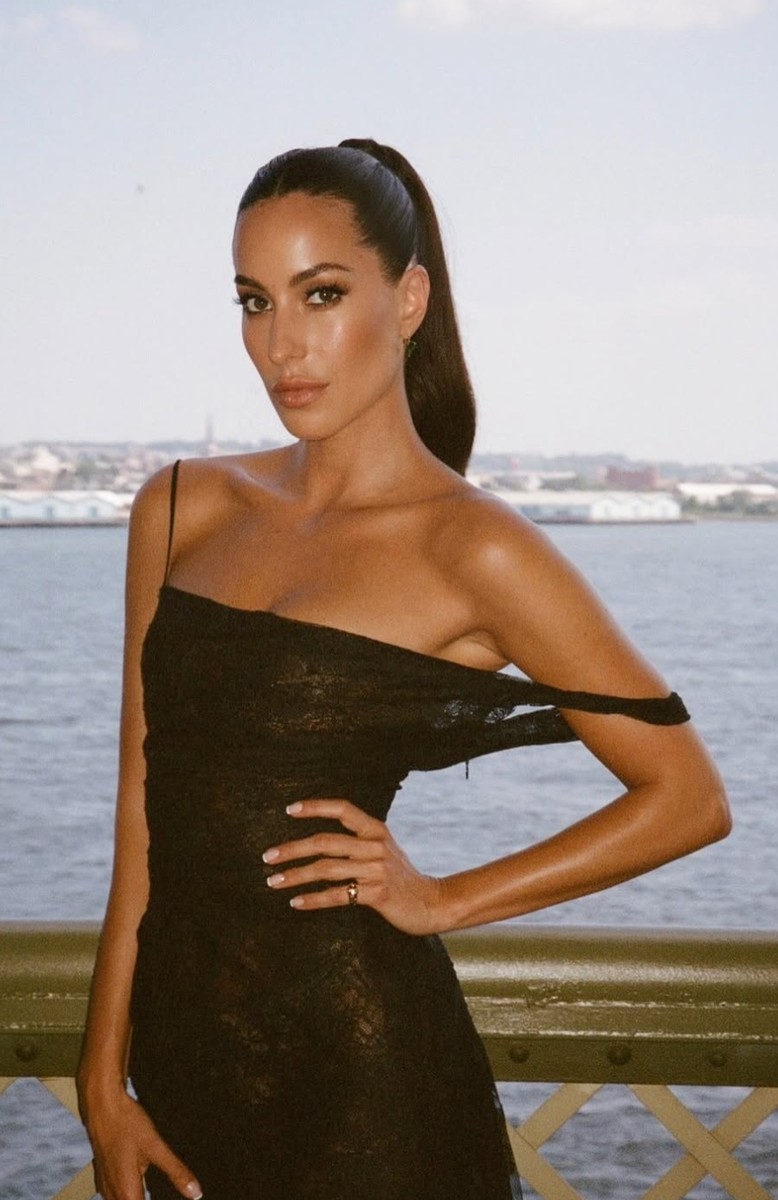 The jewelry executive accessorized with teardrop earrings while wearing her hair in a sleek high ponytail, creating a polished evening look.
