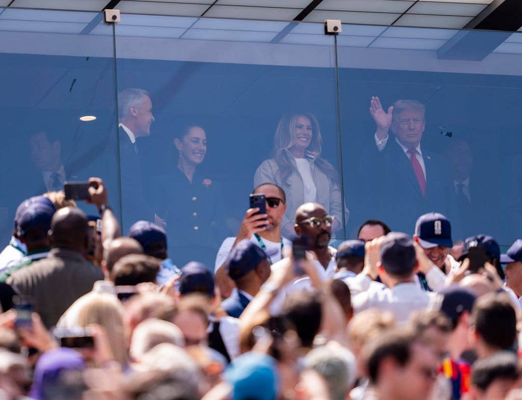 Trump posed behind a bulletproof glass