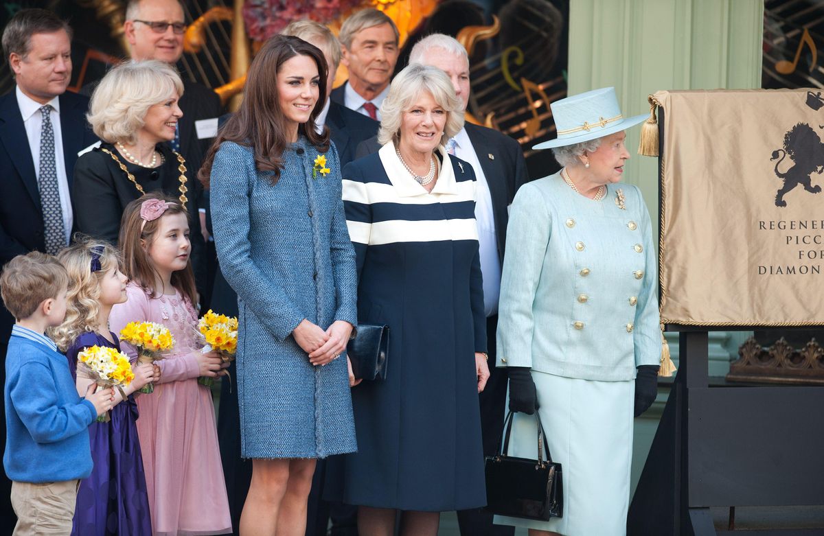 Queen Elizabeth II unveils a plaque during a visit to Fortnum & Mason in London's Piccadilly alongside Catherine, Duchess of Cambridge, and Camilla, Duchess of Cornwall, on March 1, 2012.