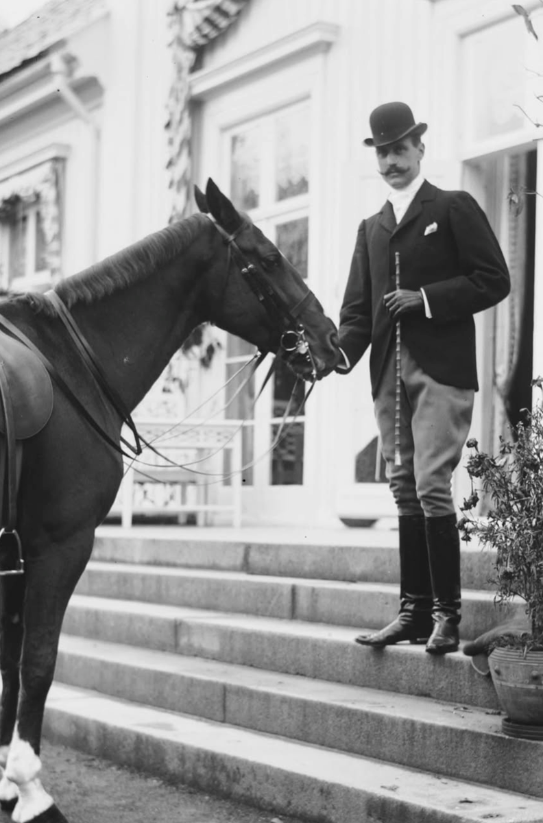 King Haakon VII poses with his horse at Bygdøy Royal Farm in 1910.