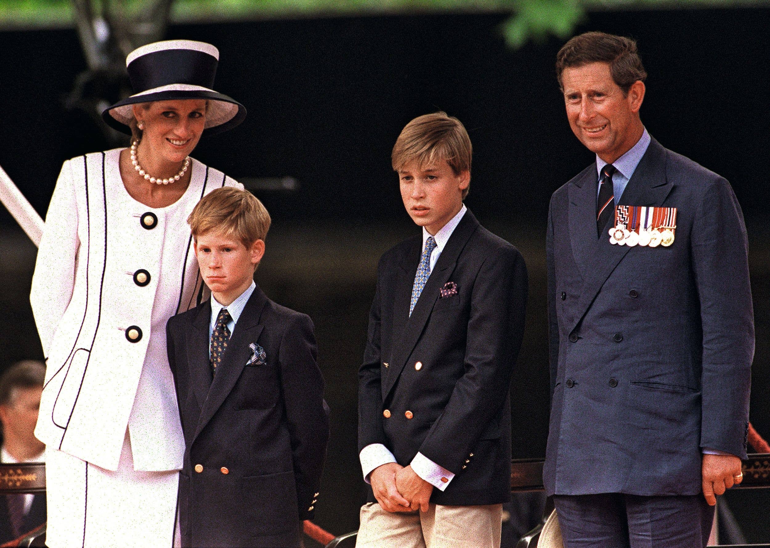 Princess Diana, Prince Harry, Prince William and Prince Charles at a parade in the Mall, London, during V.J. Day commemorations, August 1994. Diana is wearing a Tomasz Starzewski suit and a hat by Philip Somerville. (Photo by Terry Fincher/Getty Images)