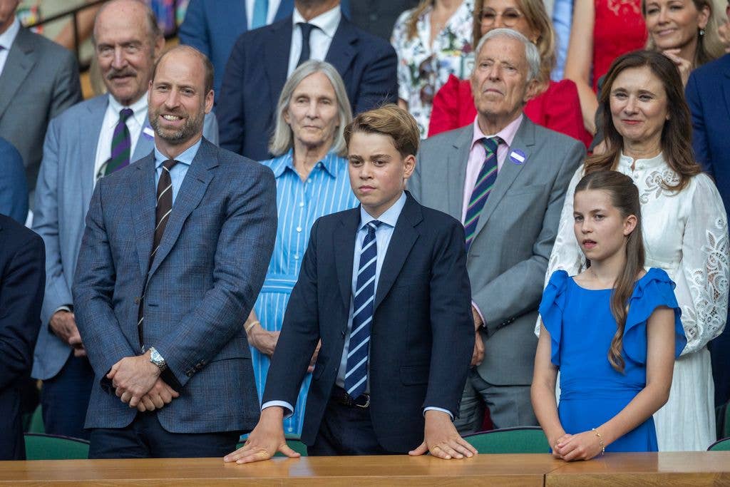 The future king coordinated with his father in a smart navy suit and striped tie.
