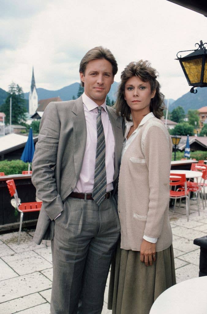 Bruce Boxleitner and Kate Jackson standing together in formal attire on an outdoor patio.