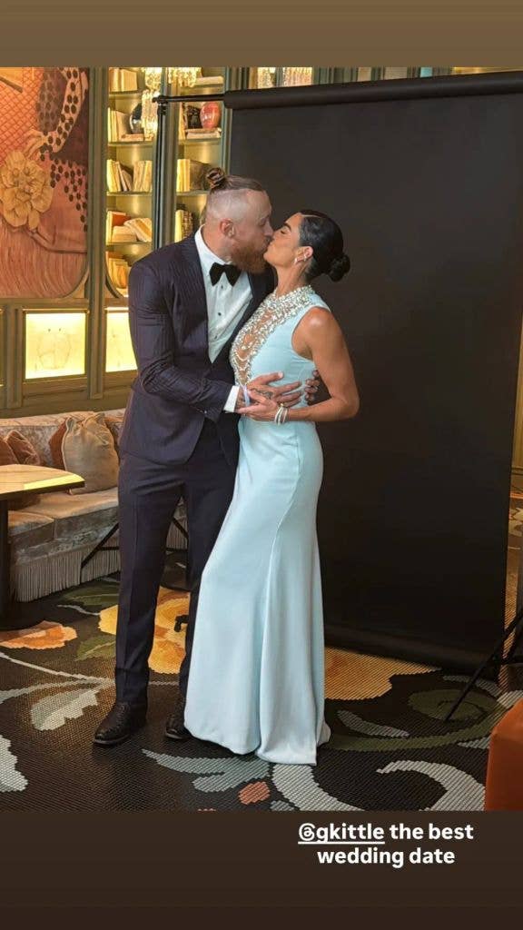 Claire and George Kittle kiss while posing for a photo ahead of Taylor Swift and Travis Kelce's wedding, shared on Instagram