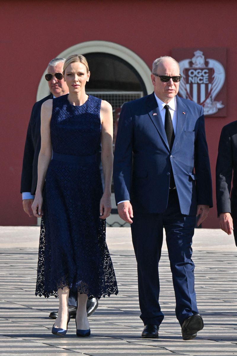 Princess Charlène embraced timeless elegance in a navy lace dress during the solemn memorial in Nice.