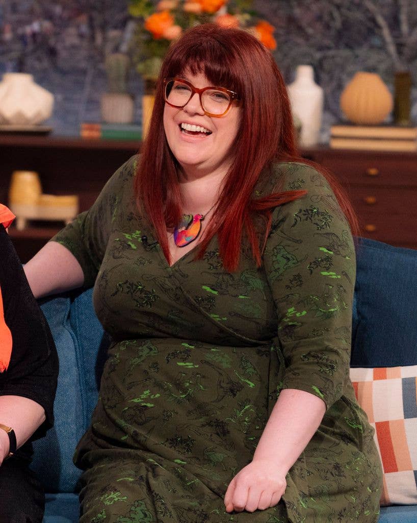 Woman with red hair sitting on blue sofa