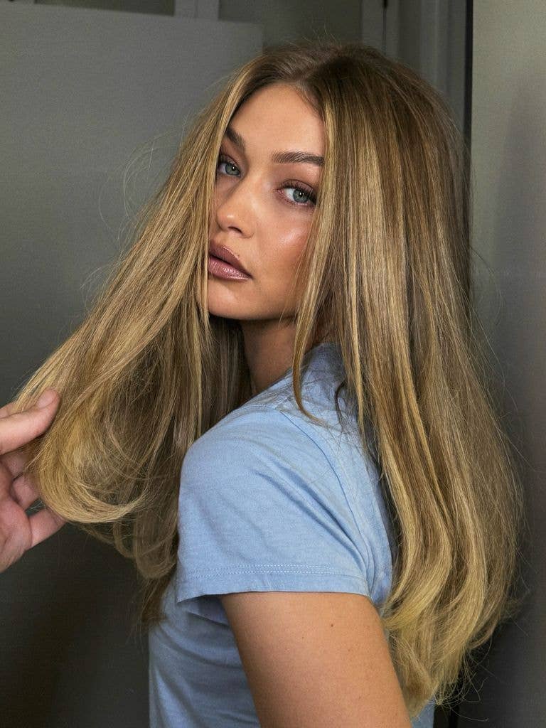 Gigi Hadid blonde hair and blue top